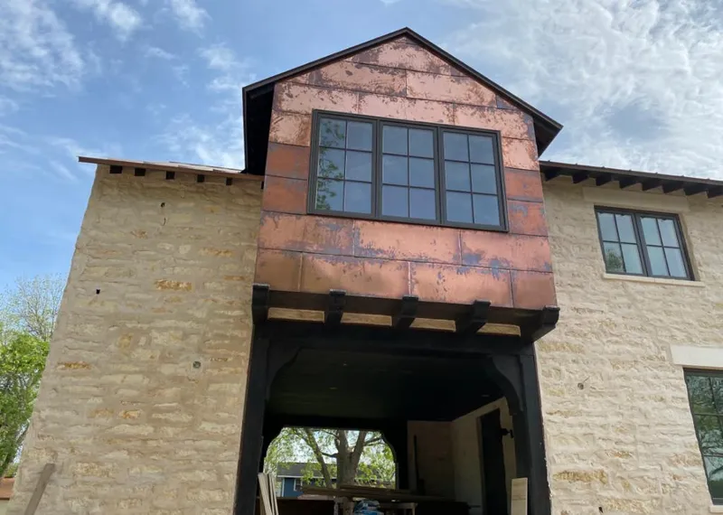 Copper metal panel facade on a stone building for Skylight Installation in Lindenhurst